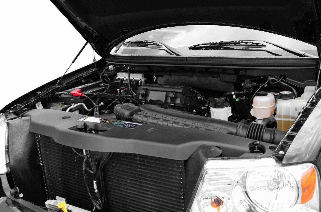 Open engine bay showing engine and components with headlights