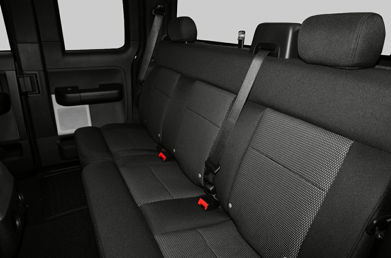 Rear bench seat upholstery with seatbelts inside truck cabin