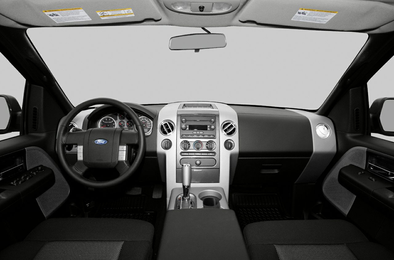 Interior dashboard with steering wheel, center console, and air vents