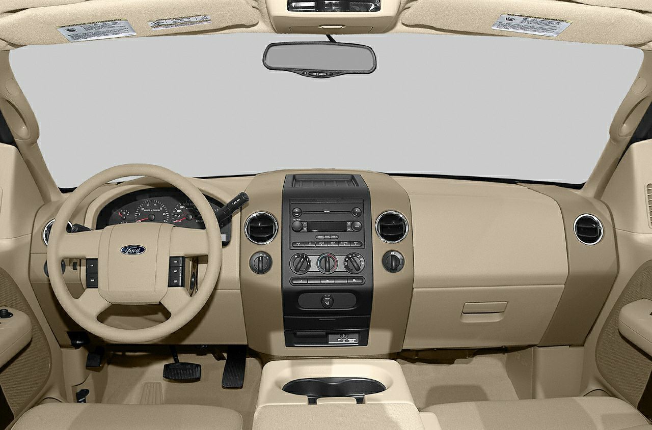 Beige dashboard, steering wheel, and center console of a truck interior