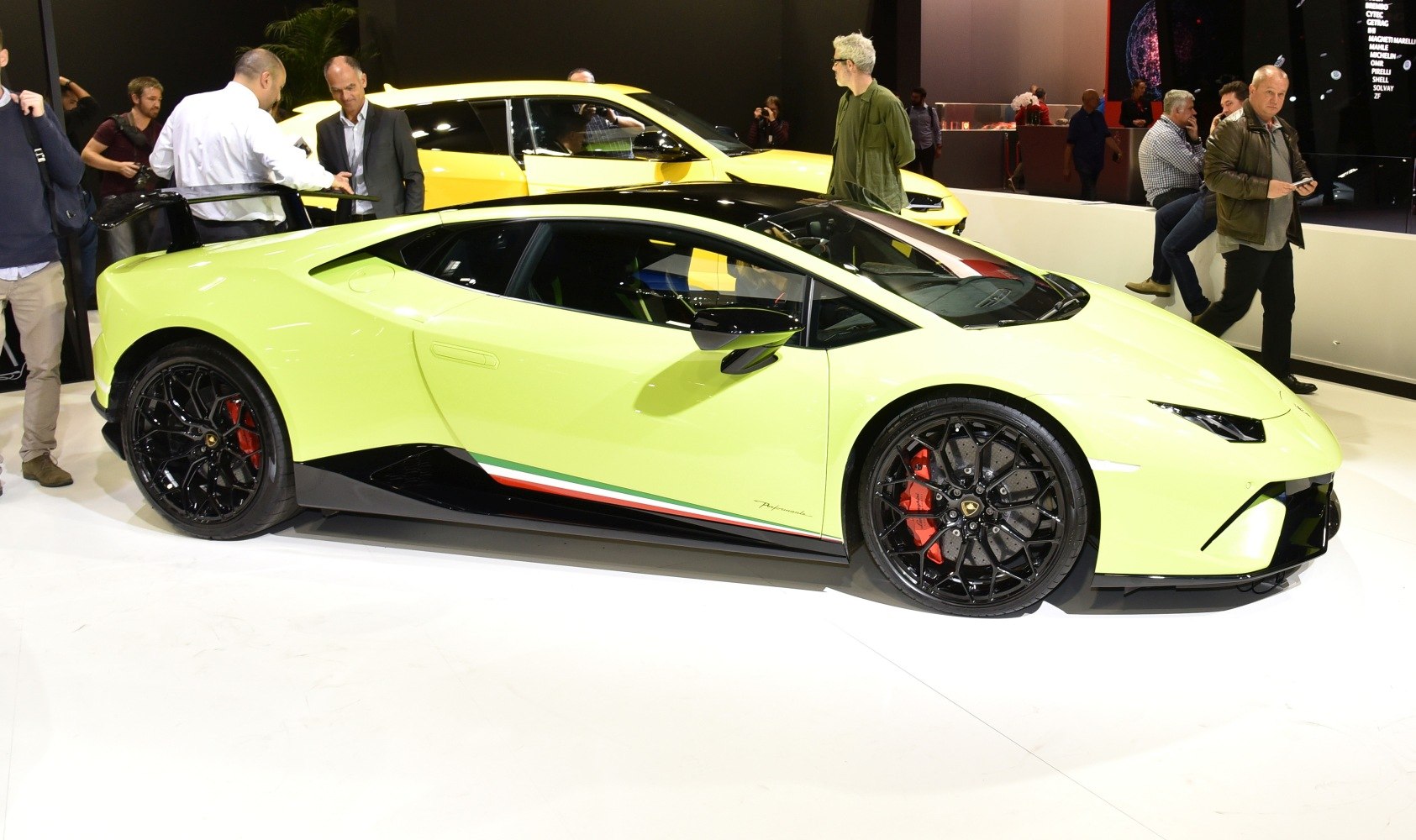 Sleek side profile with black multi-spoke wheels and red brake calipers