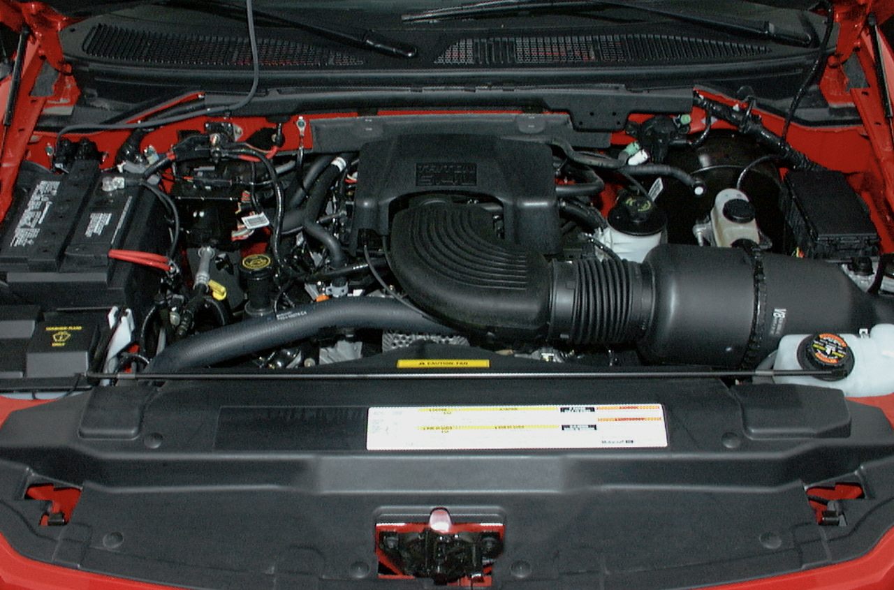 Engine bay with air intake, battery, and fluid reservoirs