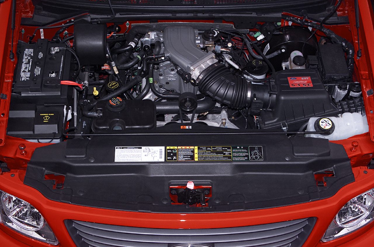 Engine bay with 5.4L V8 engine and surrounding components.