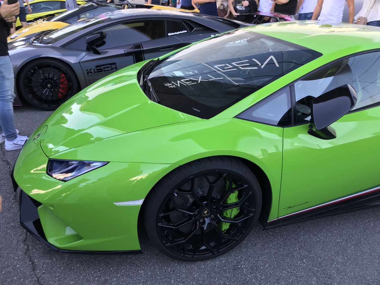 Front side view with black multi-spoke wheels and angular headlights