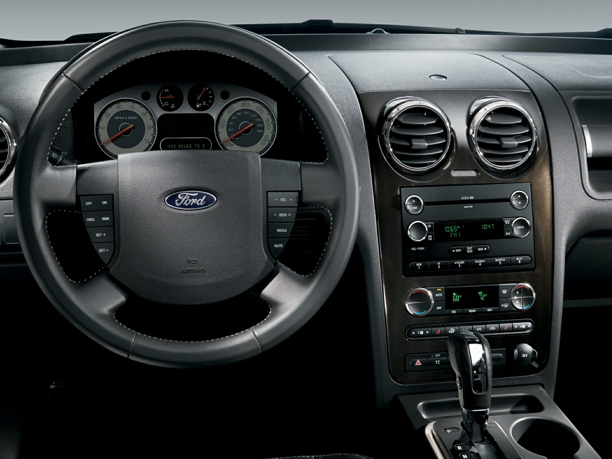 Dashboard and steering wheel with instrument cluster and center console controls