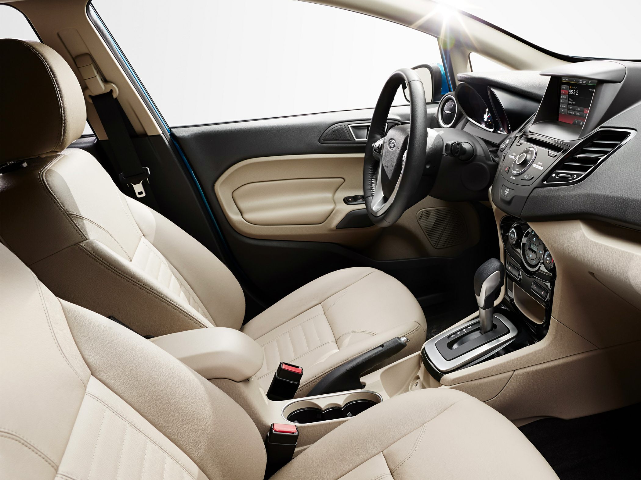 Beige interior with dashboard, steering wheel, and automatic gear shift