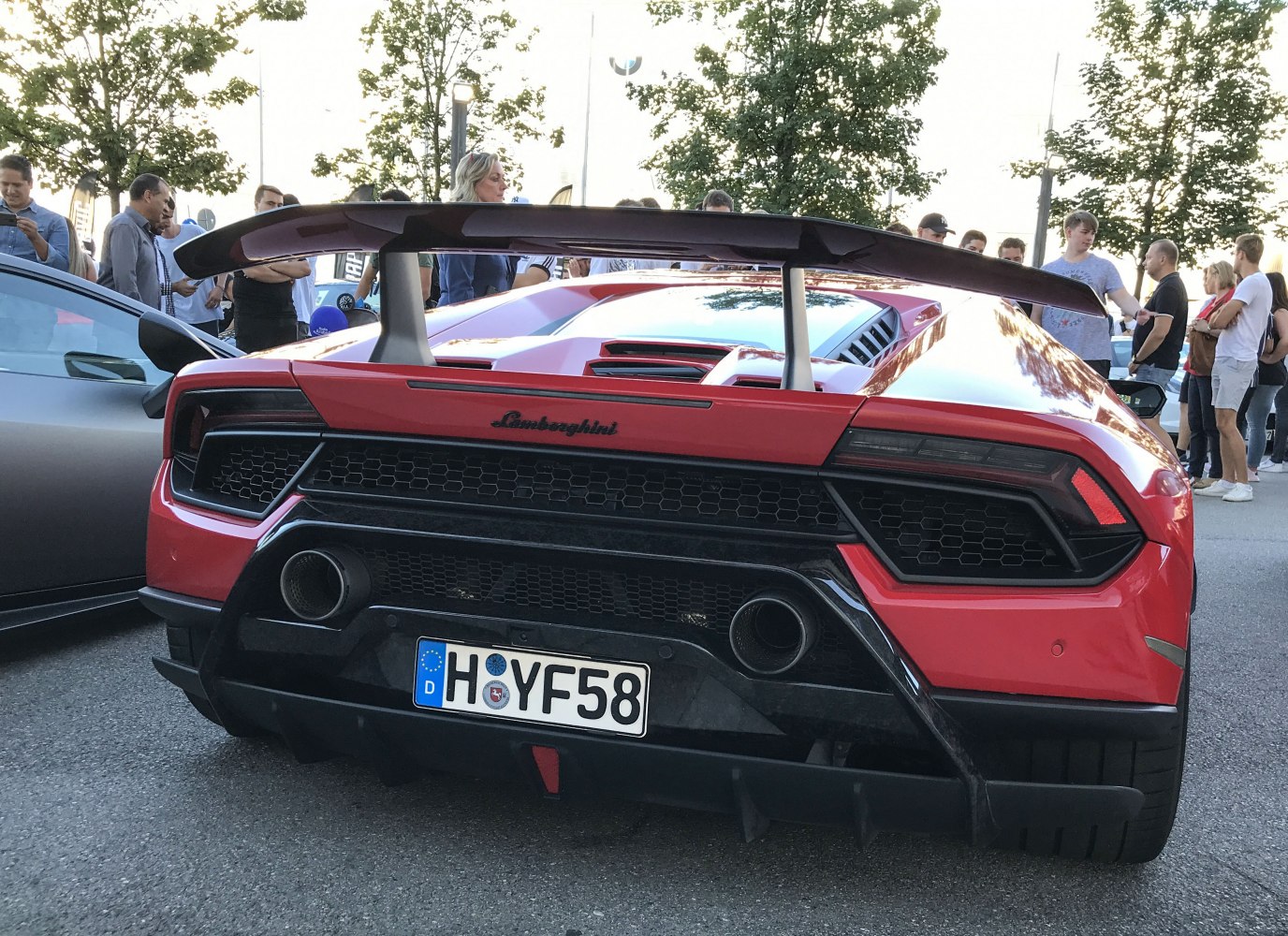 Rear view featuring large aerodynamic rear wing and dual exhausts