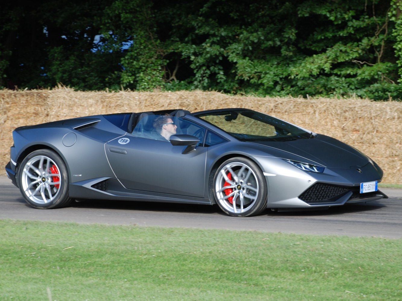 Sleek convertible sports car with aerodynamic profile and red brake calipers