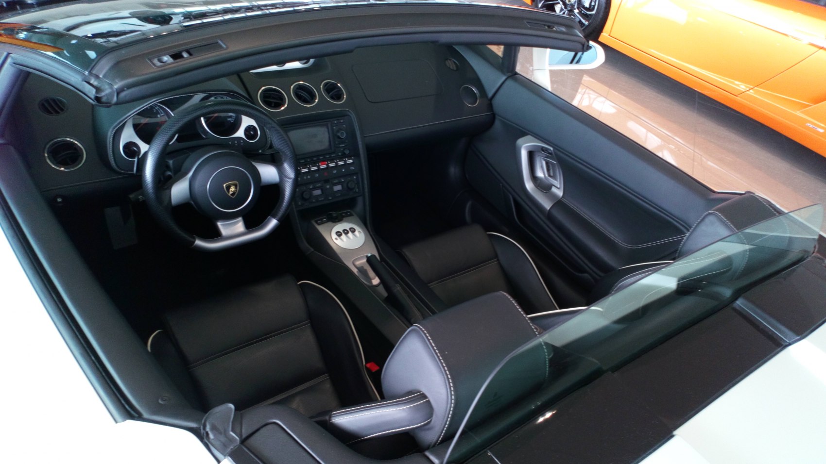 Luxury sports car interior with dashboard and steering wheel