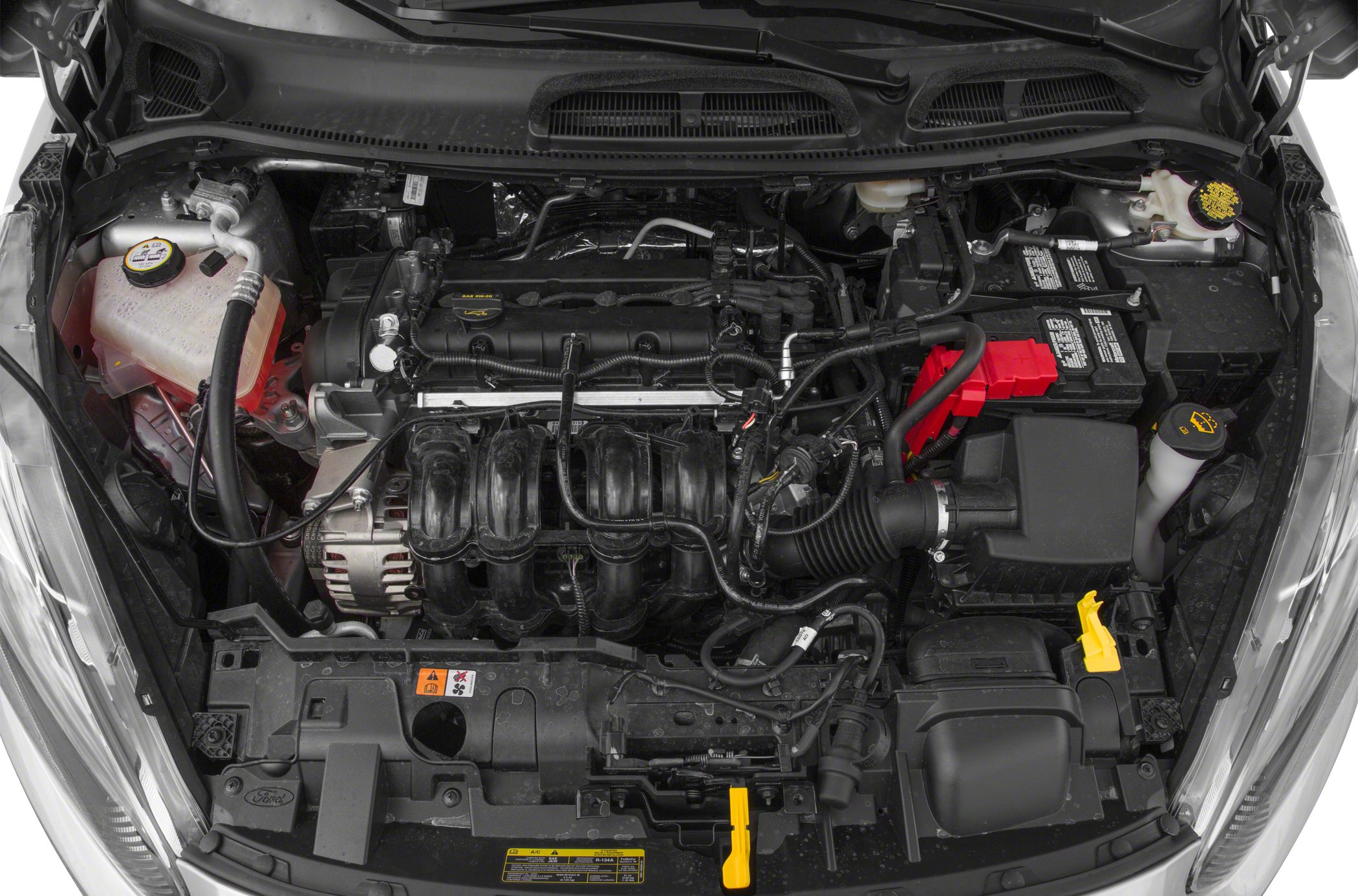 Engine bay with exposed motor and components including battery and coolant reservoir.