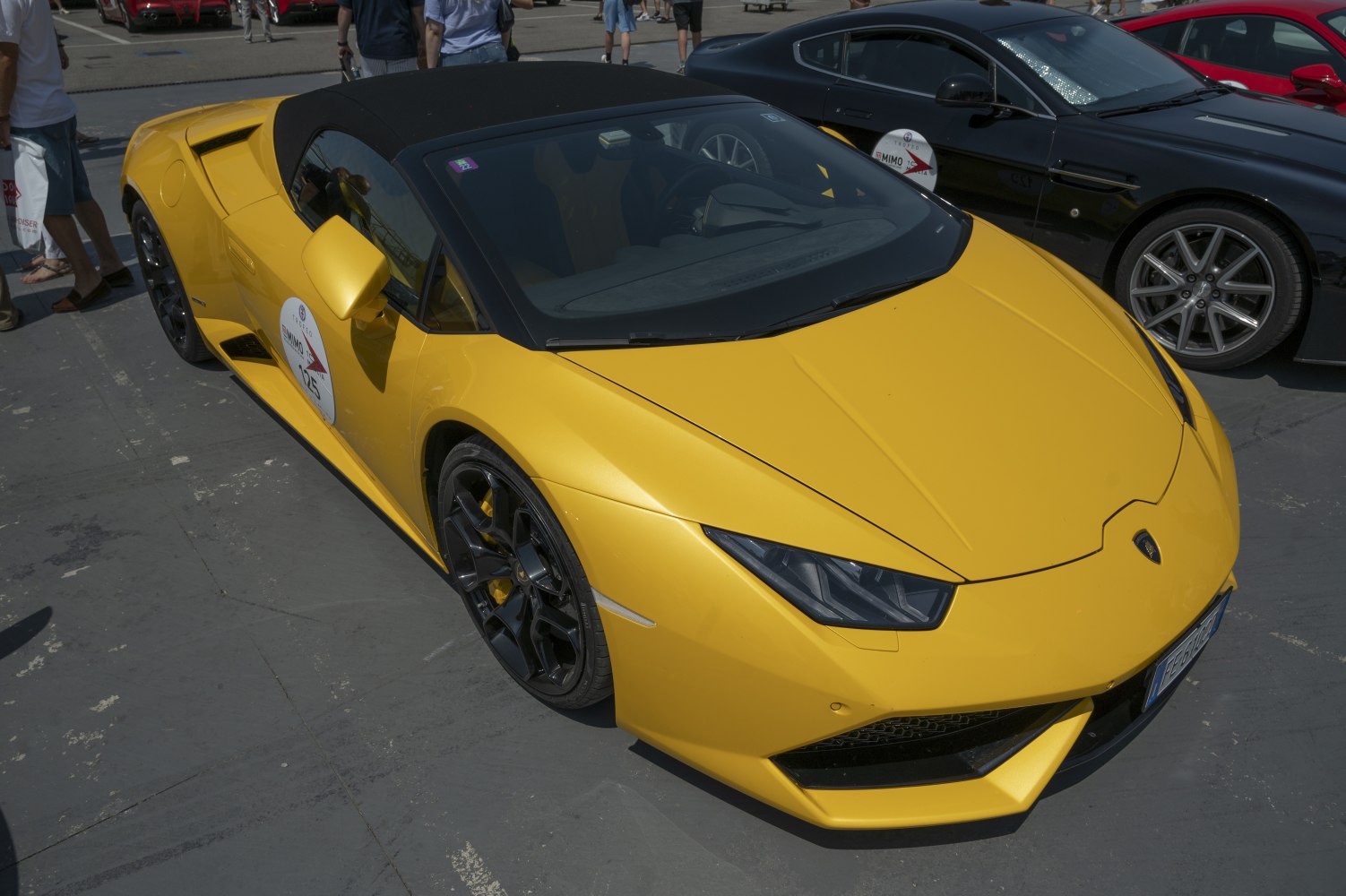 Yellow convertible sports vehicle with angular headlights and black wheels
