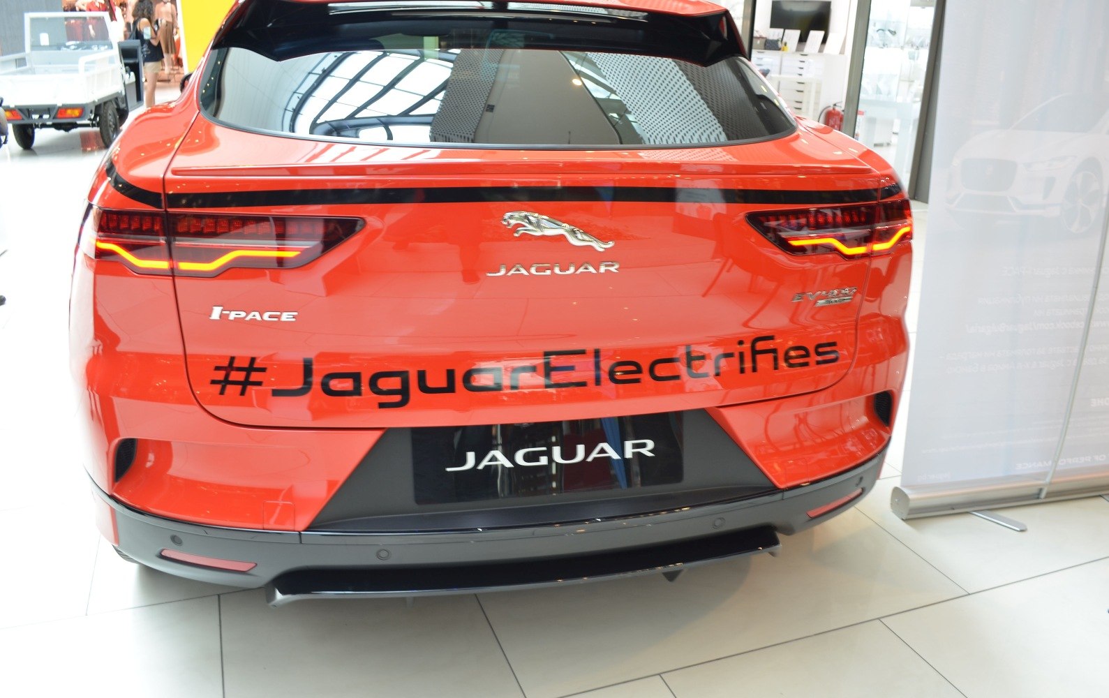 Rear view of electric SUV with distinctive taillights and Jaguar badge