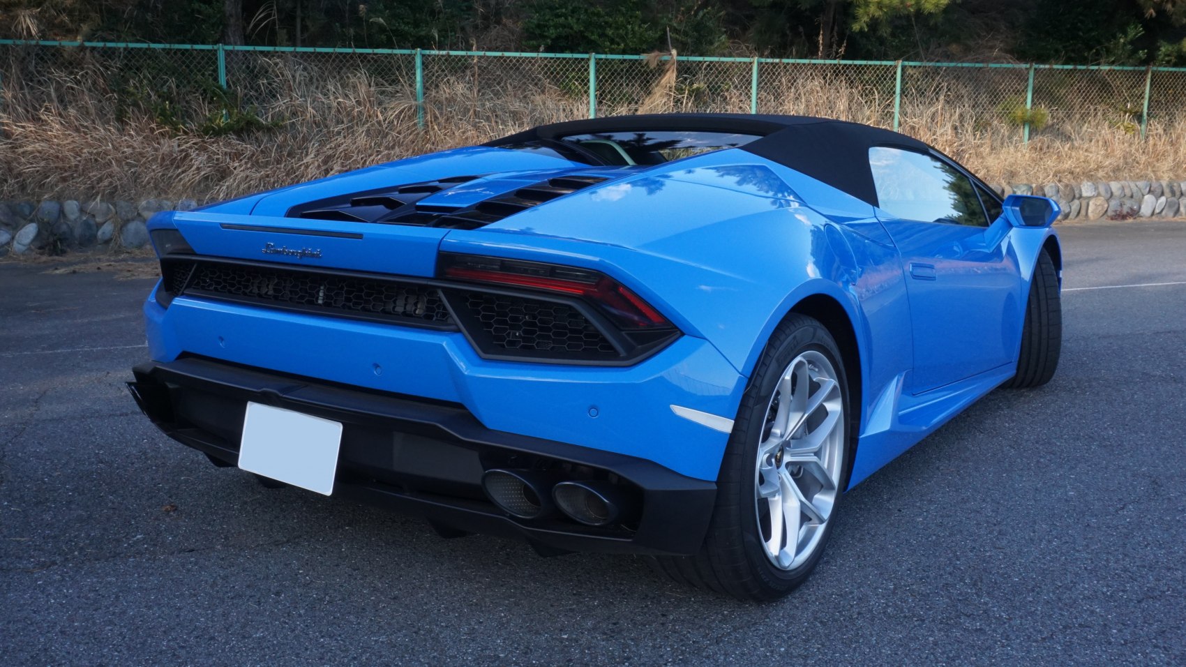 Rear view of a convertible sports coupe with dual exhaust and uniquely styled taillights