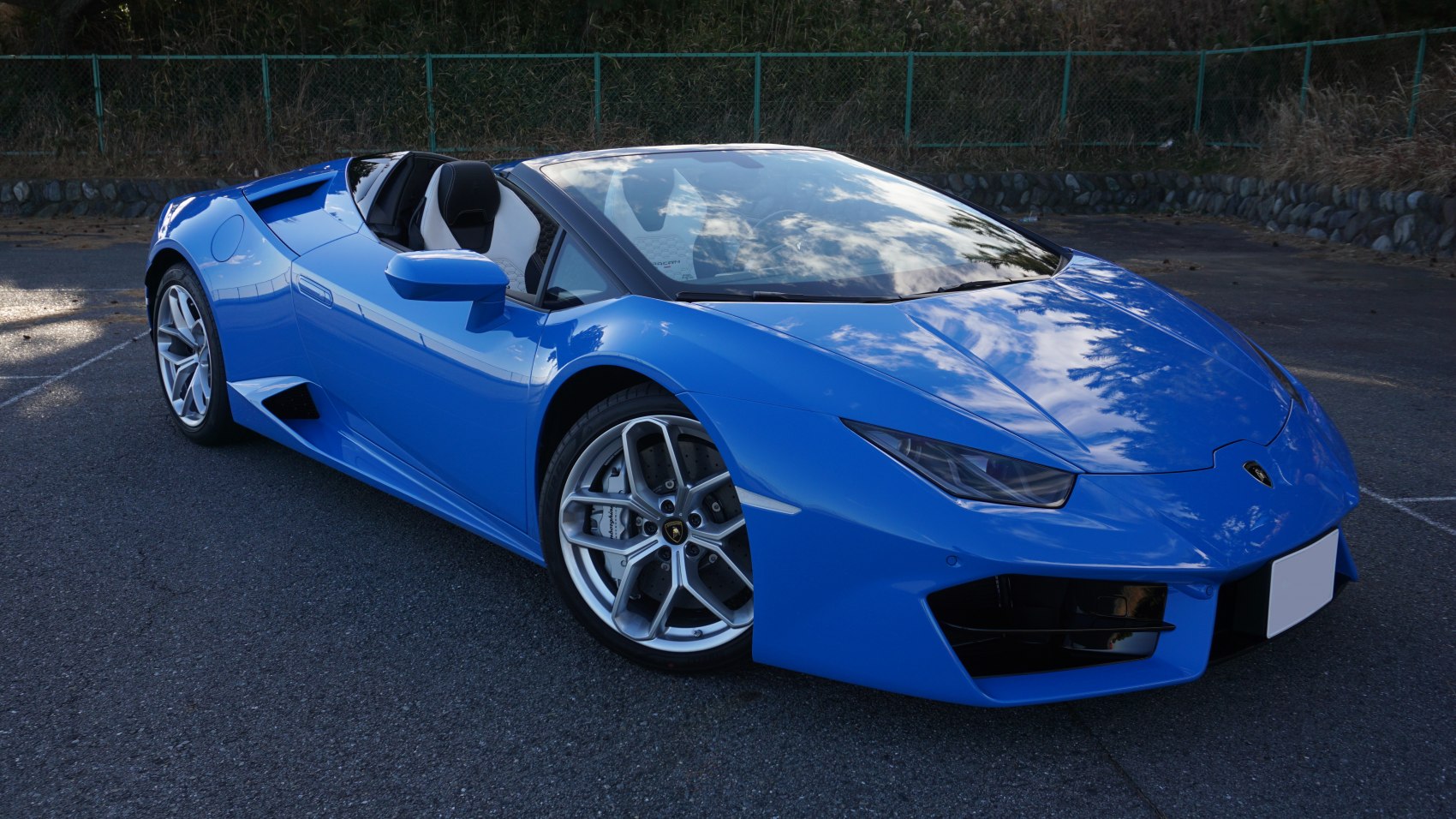 Blue convertible with aerodynamic body and sharp headlights