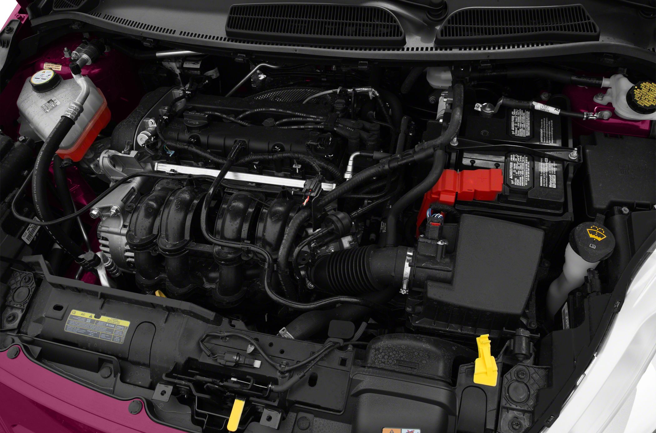Engine bay with intake manifold, battery, coolant reservoir, and wiring