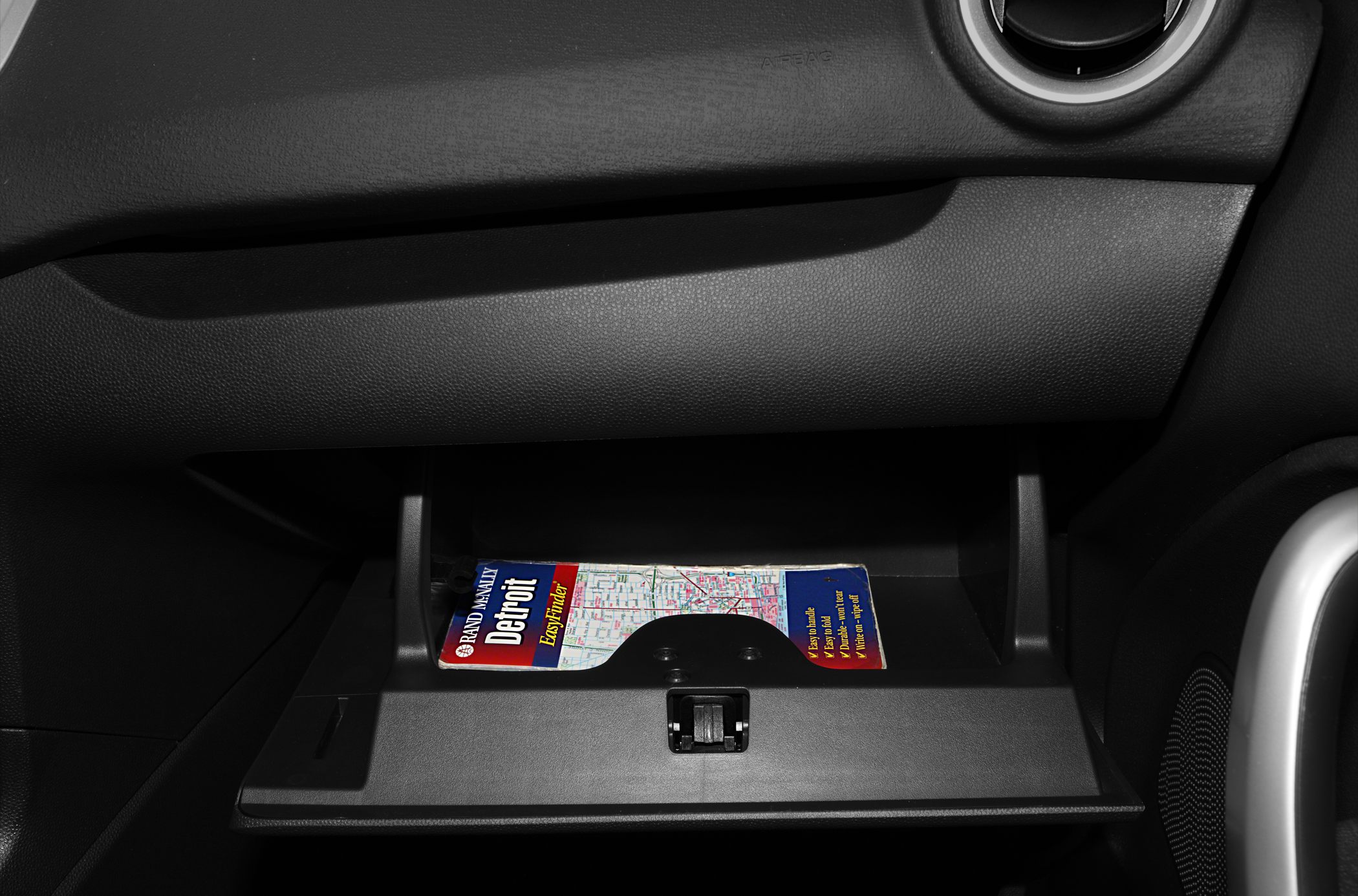 Car glove box compartment with a city map inside