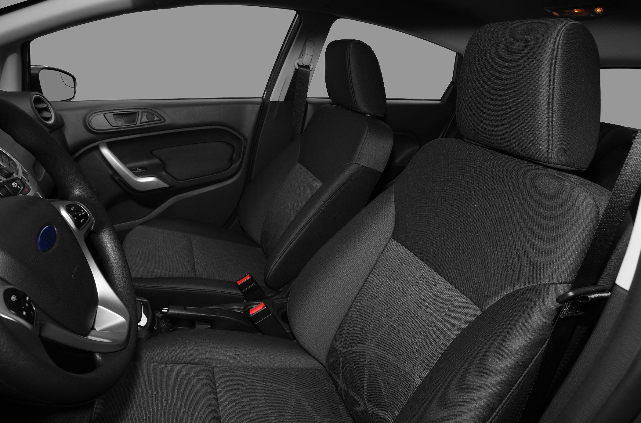 Front seats, steering wheel, dashboard, and door panel interior features