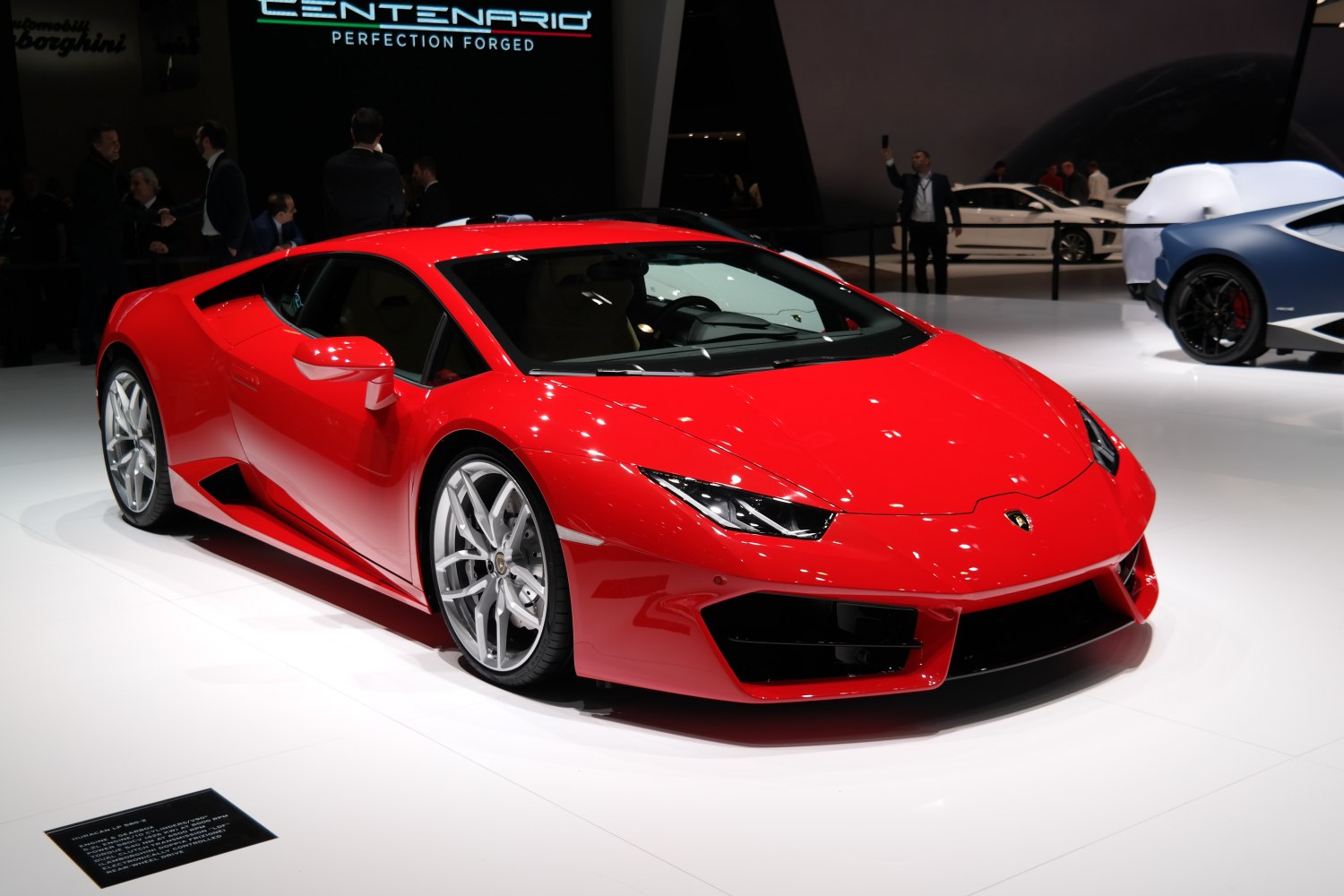 Red low-profile sports coupe with angular headlights and silver wheels