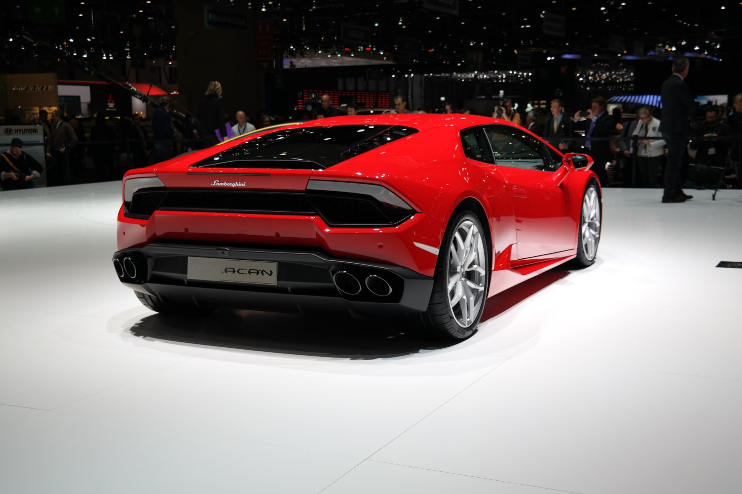 Rear view of a red sports car with quad exhaust and aerodynamic design