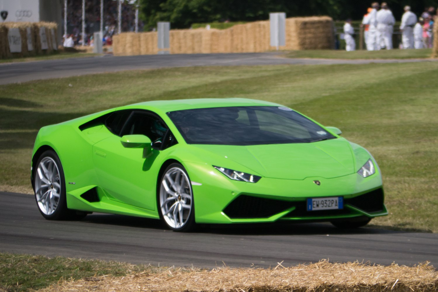 Bright green sports car front side on track