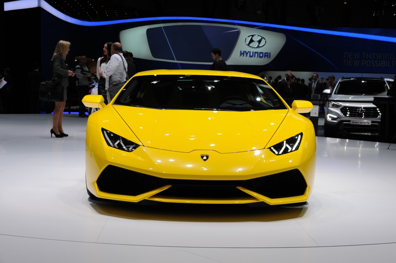 Yellow sports car front with sharp headlights and aggressive grille