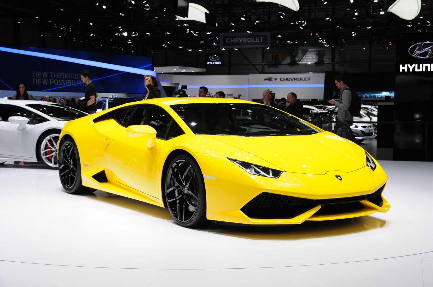 Yellow sports car with aerodynamic shape and sharp headlights.