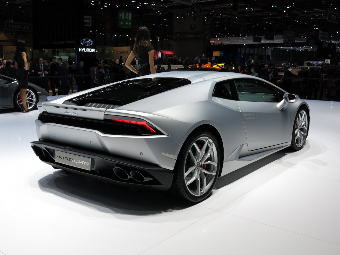 Silver silver luxury sports car rear and side with angular lights and dual exhaust