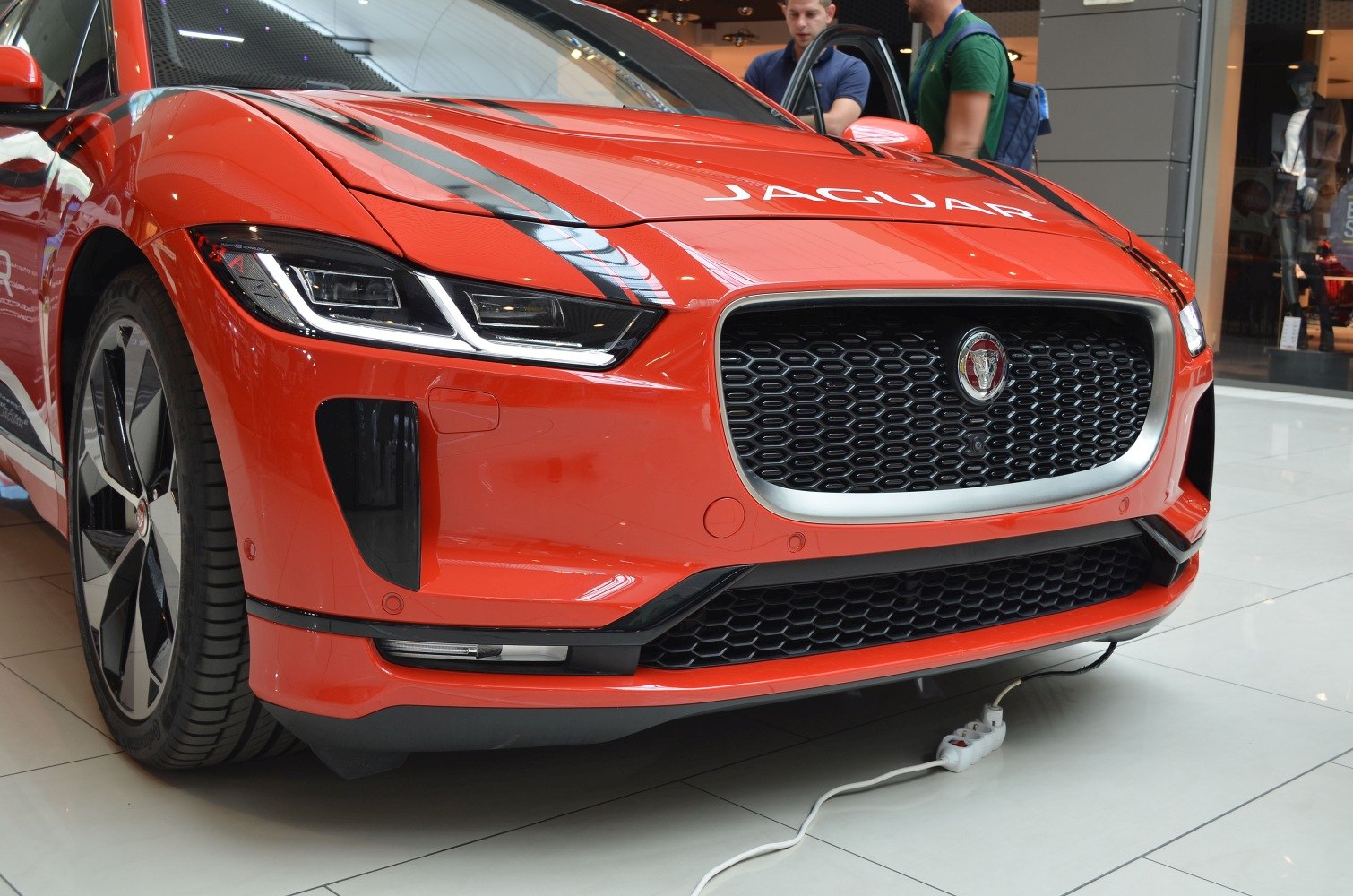 Close-up of front grille with emblem and LED headlight