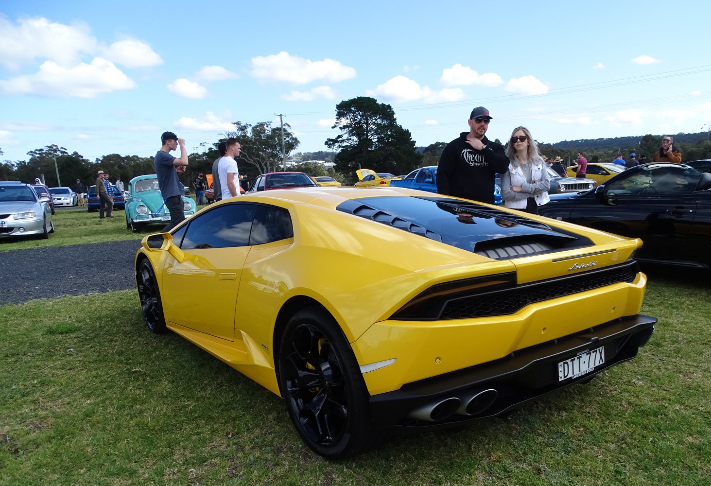 Yellow sports car rear side with black alloy wheels