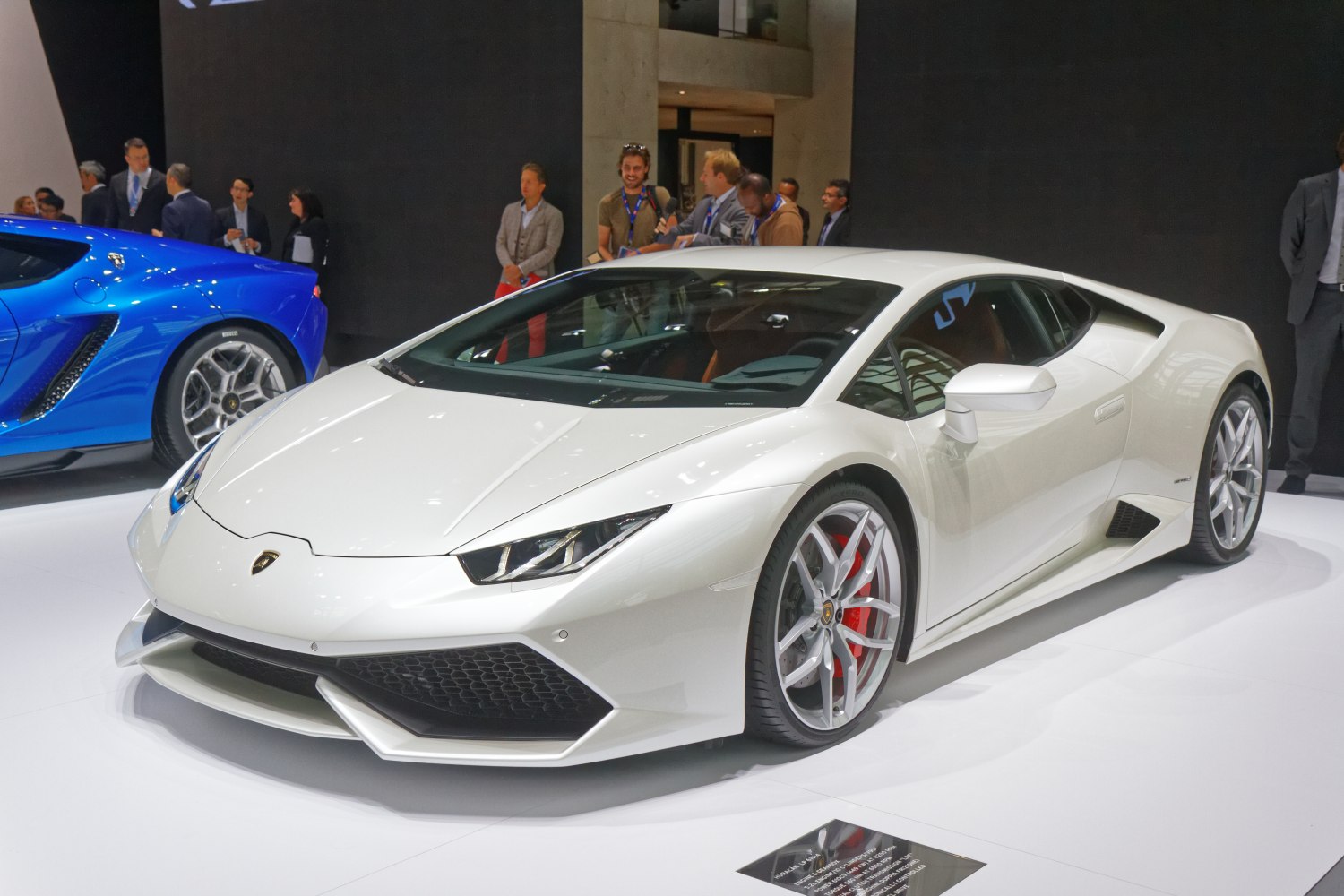 Sharp headlights and sporty alloy wheels on a sleek vehicle front and side profile