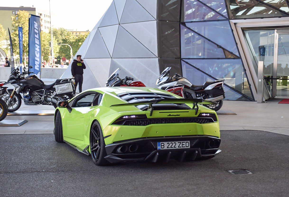 Rear view with prominent aerodynamic spoiler and quad exhausts