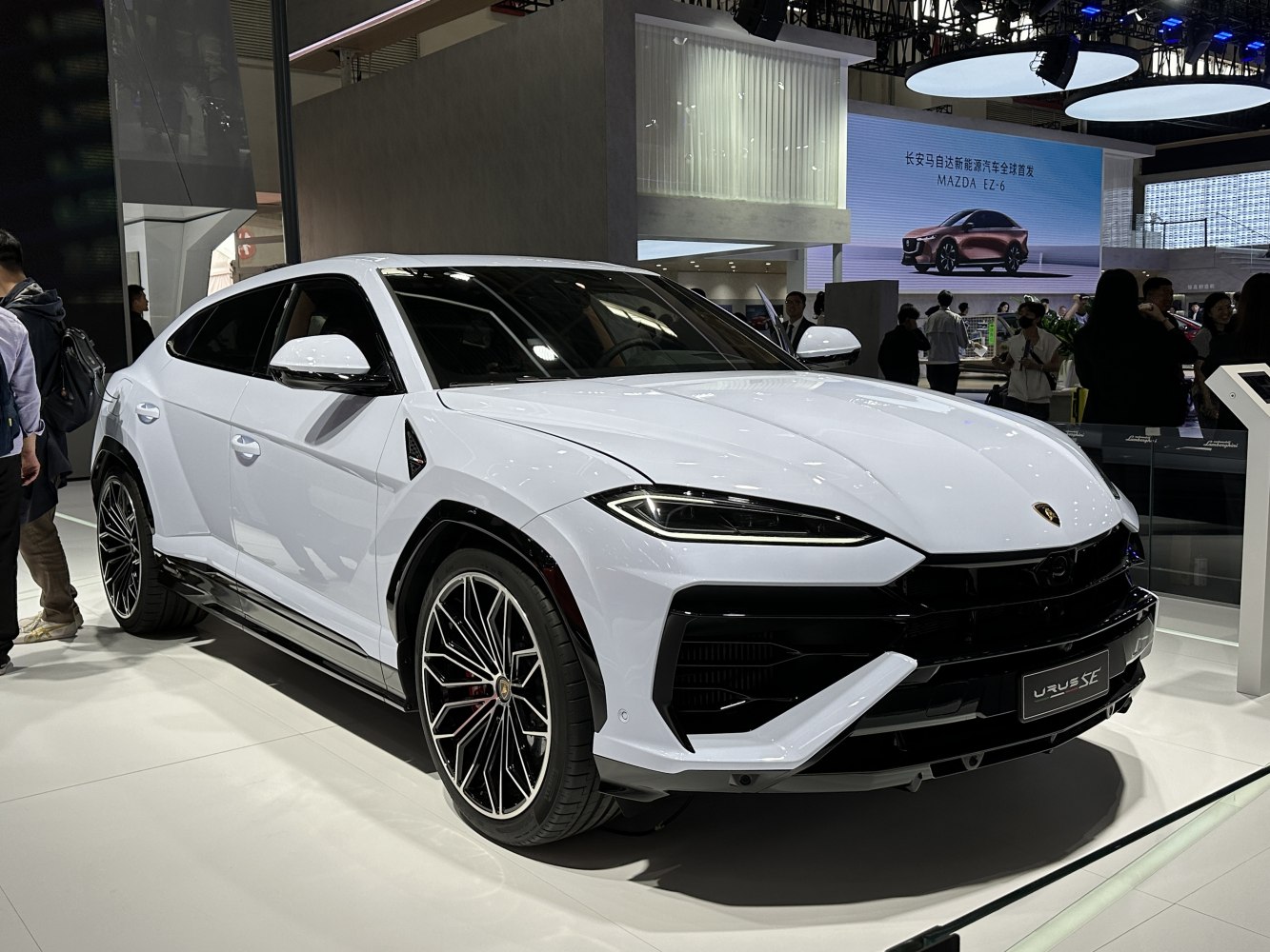 Sharp headlights and sporty alloy wheels on a white SUV front-side view
