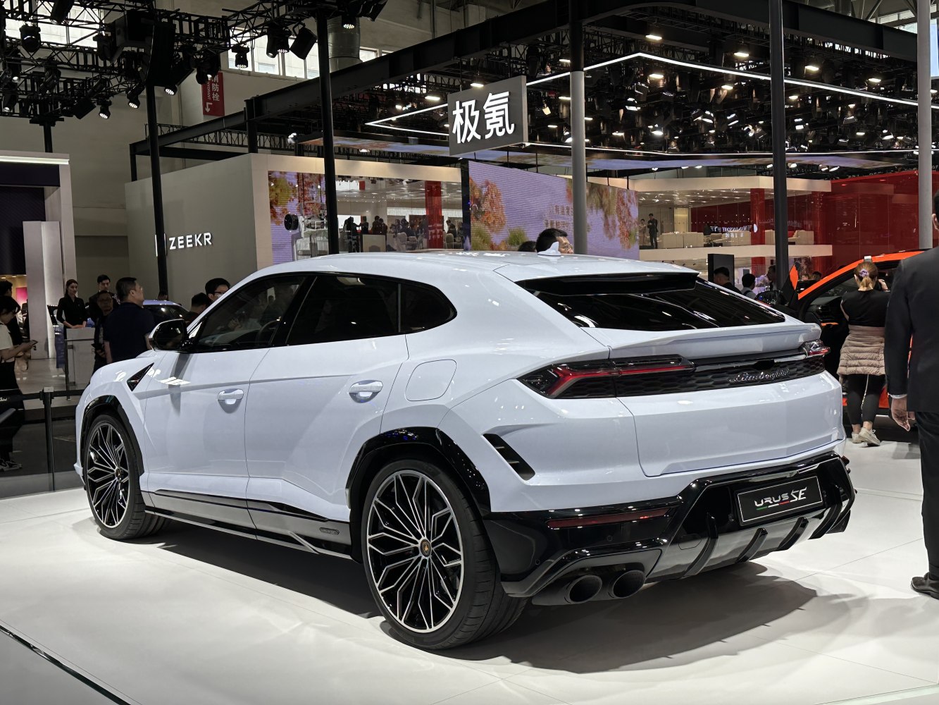 Rear three-quarter view of white luxury SUV with sporty rear diffuser and detailed tail lights