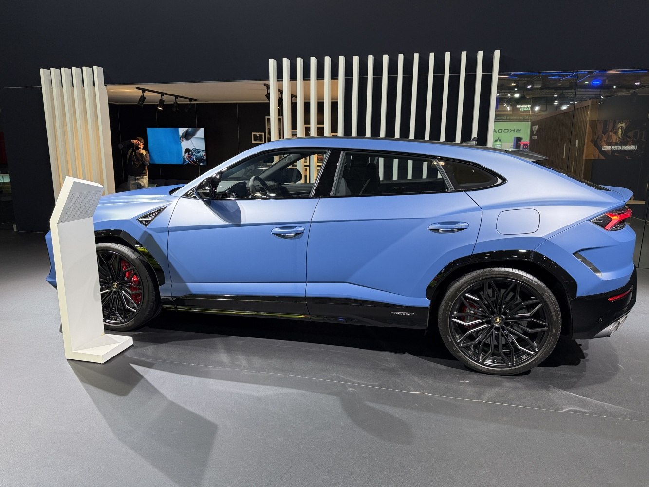 Side profile of a blue luxury SUV with black alloy wheels