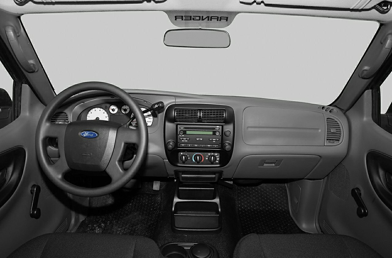 Dashboard, steering wheel, manual window controls in vehicle interior