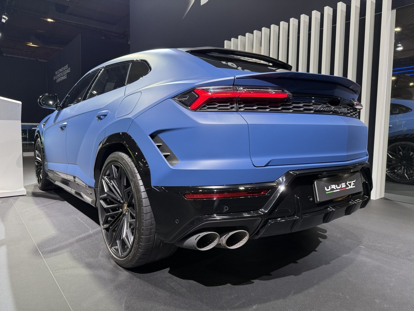 Rear view with quad exhaust and modern taillights of a sporty SUV