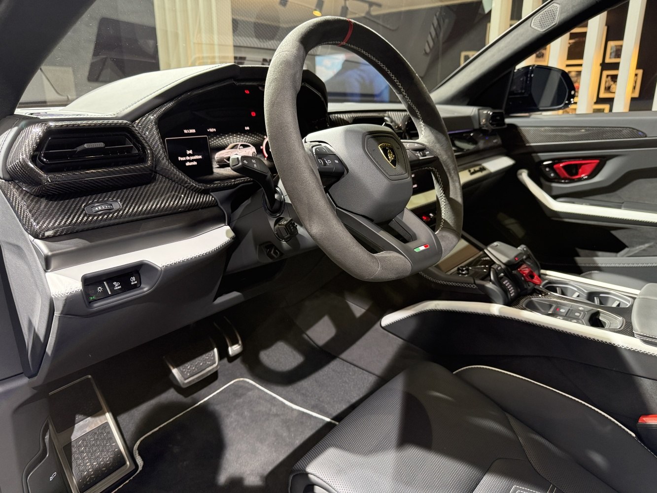 Sporty steering wheel and carbon fiber dashboard in luxury SUV interior