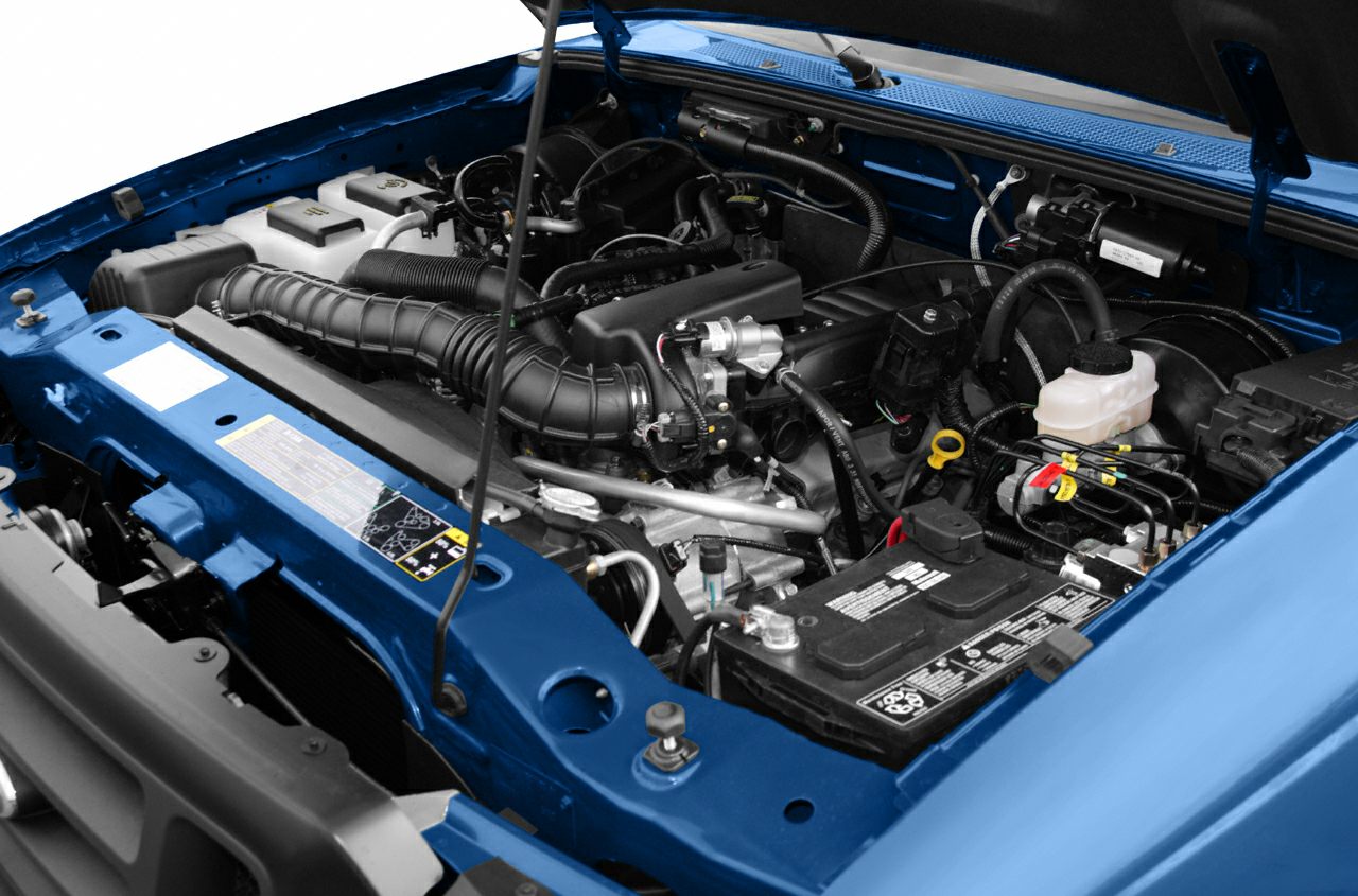 Engine bay with detailed view of components in a pickup truck Super Cab.