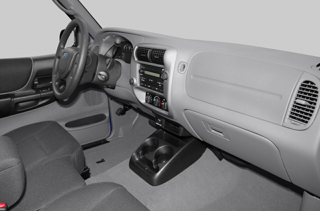 Interior dashboard, steering wheel, and center console of a vintage truck