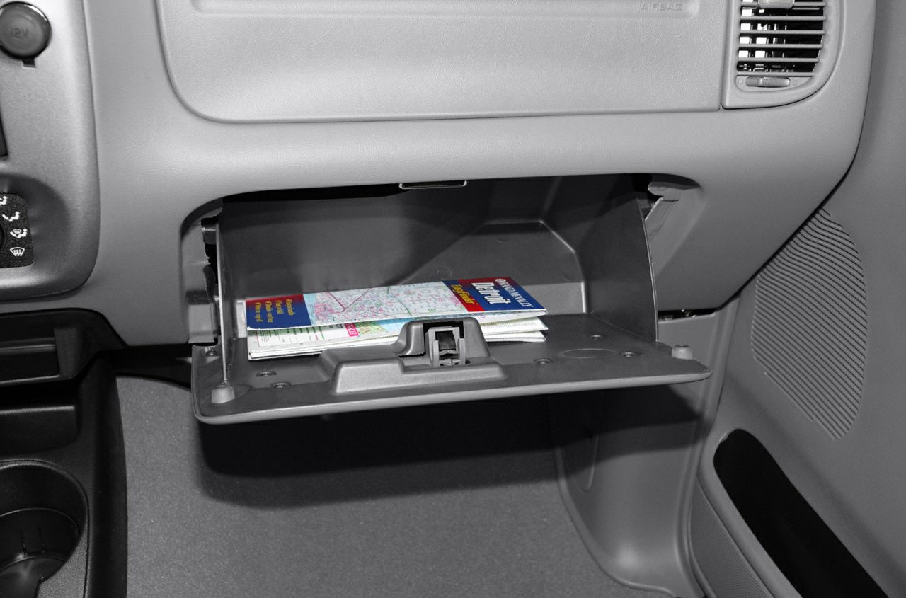 Open glove compartment with folded maps inside