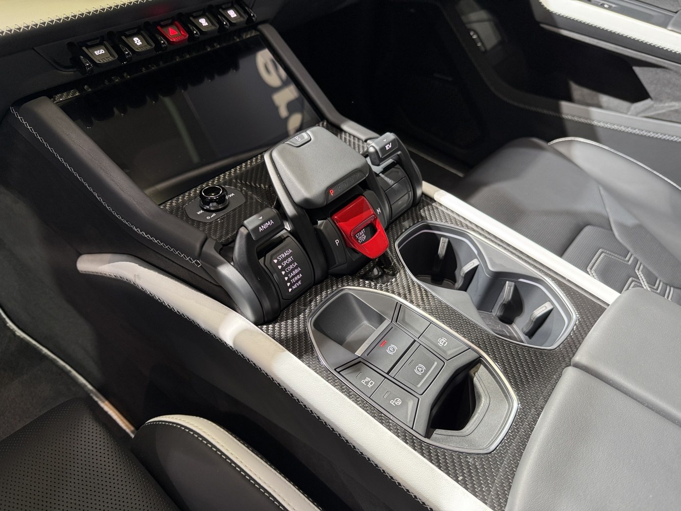 Carbon fiber trimmed center console with drive mode selector and ergonomic controls