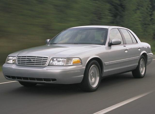 Silver full-size sedan driving on road front and side view
