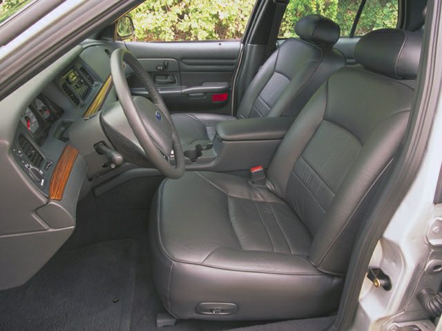 Leather front seats and dashboard with wooden trim in vehicle interior
