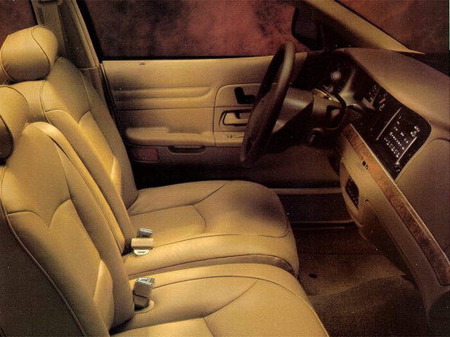 Beige leather seats and dashboard layout of a classic car interior
