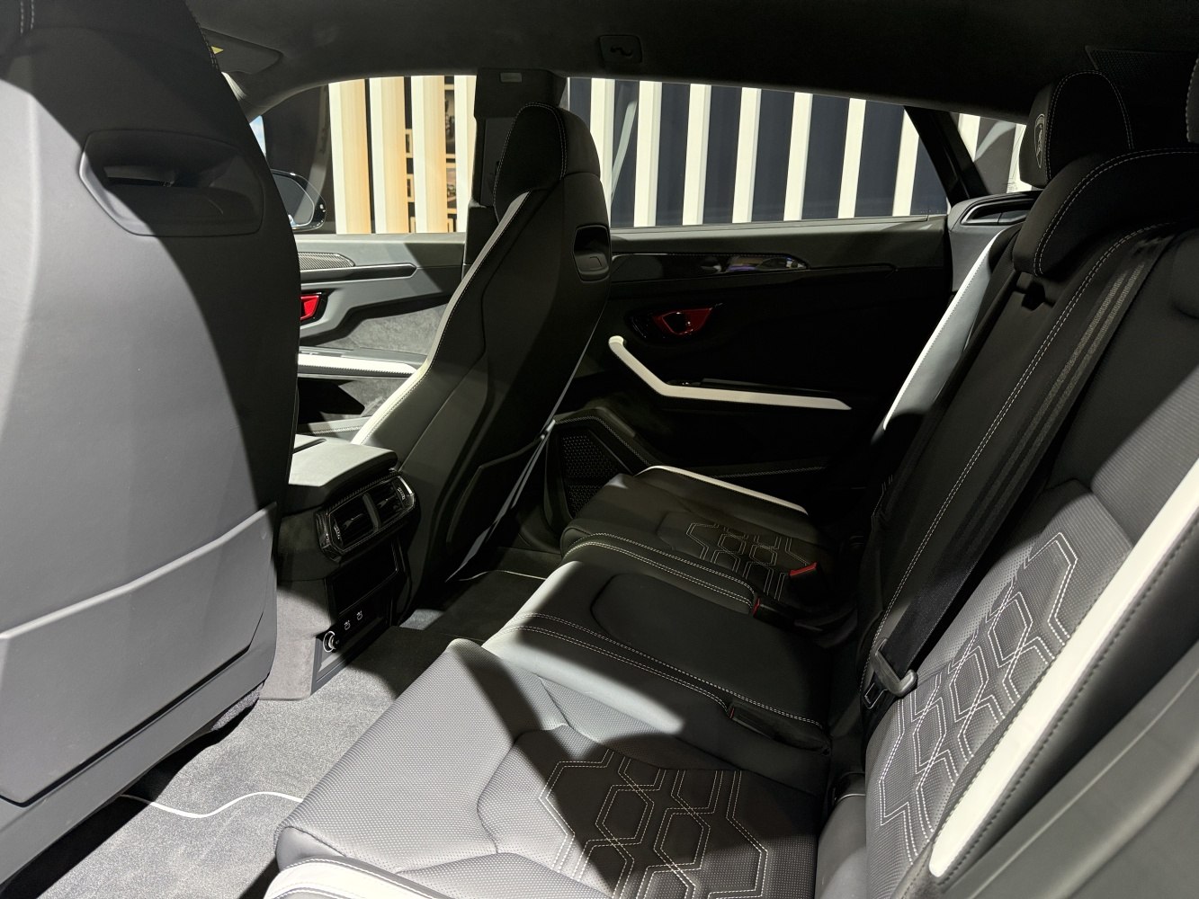 Luxury stitched black leather rear seats with ventilation and door panel design