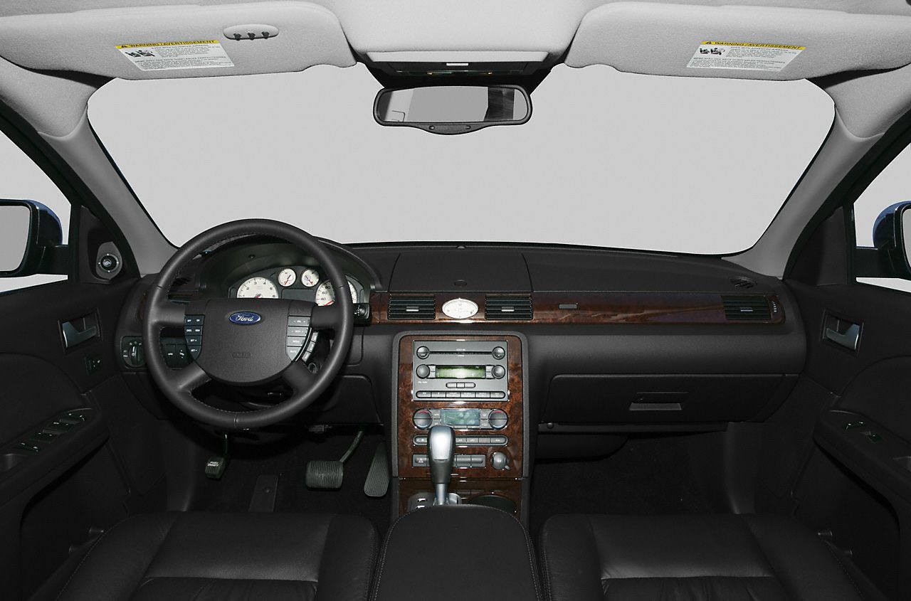Wooden inlay dashboard with multifunction steering wheel and analog gauges