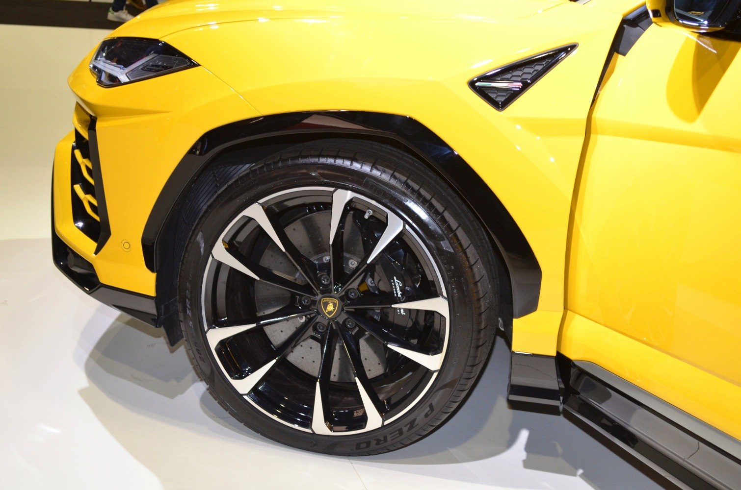 Front wheel with black and silver alloy rim and sharp headlight design