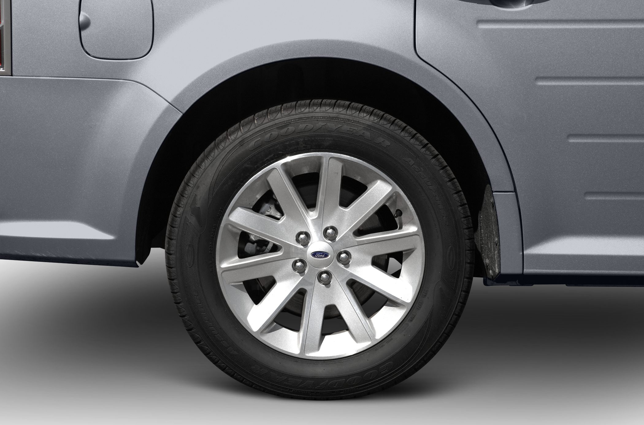 Close-up of alloy wheel and tire with brand logo