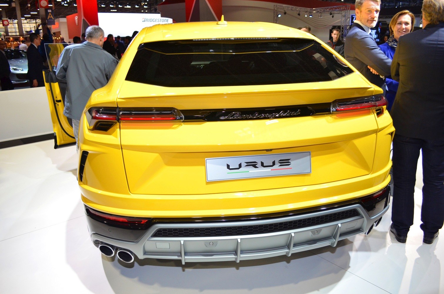 Yellow SUV rear with taillights, quad exhausts, and diffuser