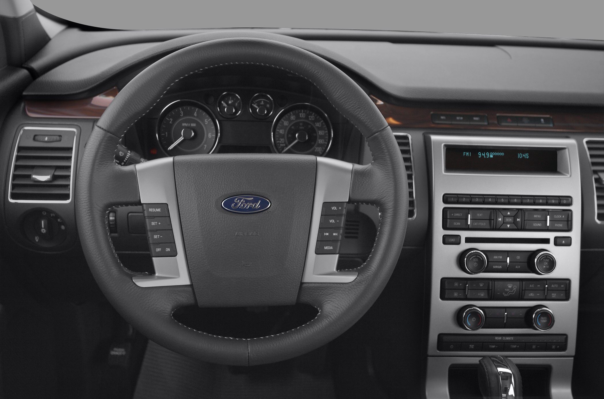 Dashboard and multifunction steering wheel with control buttons and radio display